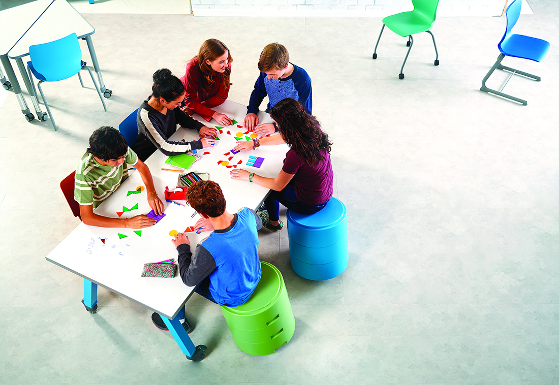 A photograph of children collaborating on a project in a classroom