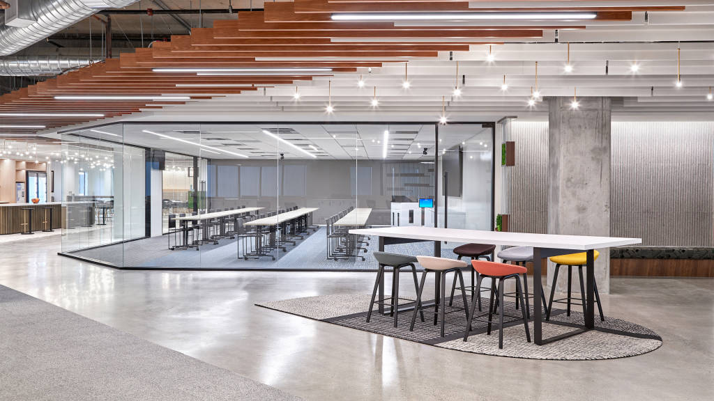 A photograph of a collaborative workspace and a glass-fronted training/meeting room at the DoorDash offices